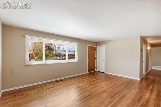 2928 Drakestone Dr, Colorado Springs, CO 80909 - unfurnished room featuring baseboards, light wood-style flooring, and visible vents