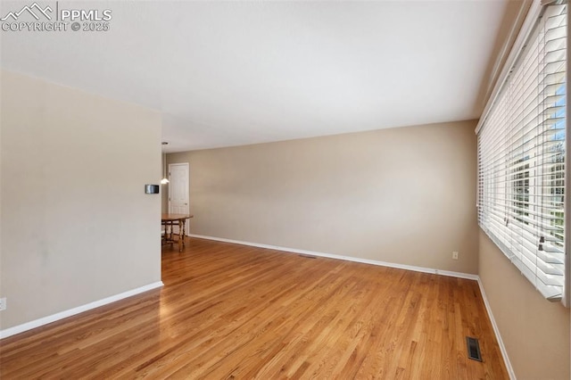 2928 Drakestone Dr, Colorado Springs, CO 80909 - spare room with visible vents, light wood finished floors, and a wealth of natural light
