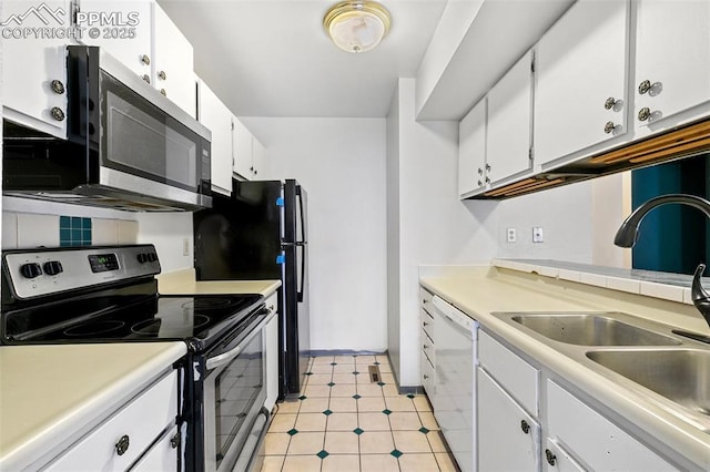 kitchen featuring stainless steel appliances, light countertops, white cabinetry, and a sink