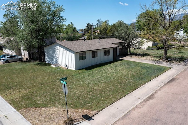 405 Aztec Dr, Colorado Springs, CO 80911 - view of front of house featuring a front lawn, a garage, and a shingled roof