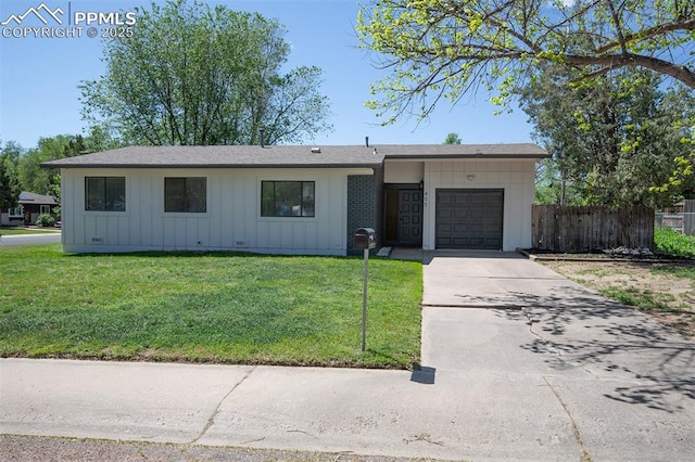 405 Aztec Dr, Colorado Springs, CO 80911 - ranch-style home with board and batten siding, a garage, concrete driveway, and a shingled roof