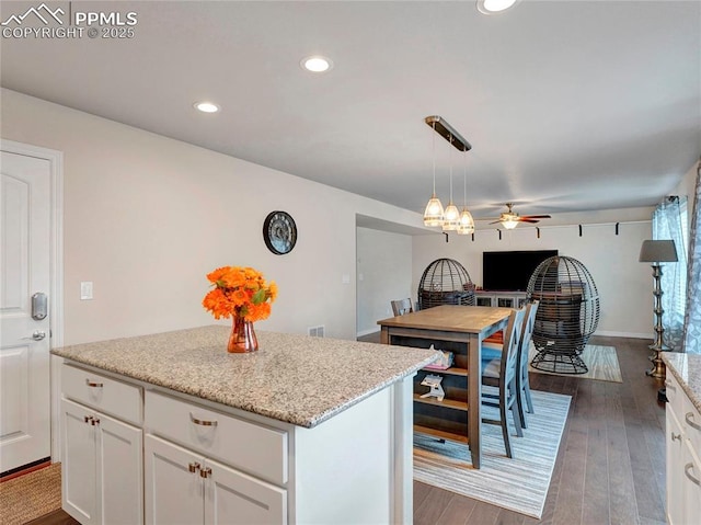 kitchen with a ceiling fan, white cabinetry, light wood-type flooring, decorative light fixtures, and recessed lighting