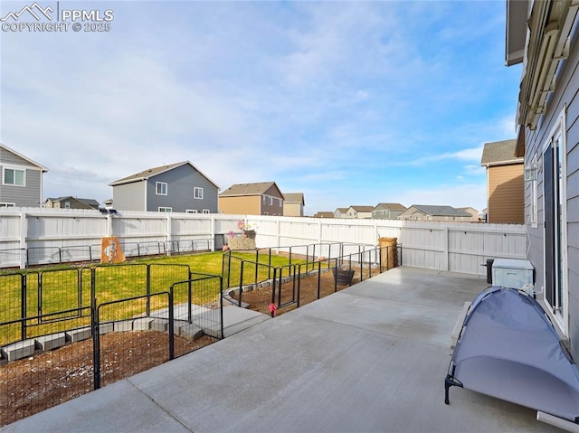 view of patio with a fenced backyard and a residential view