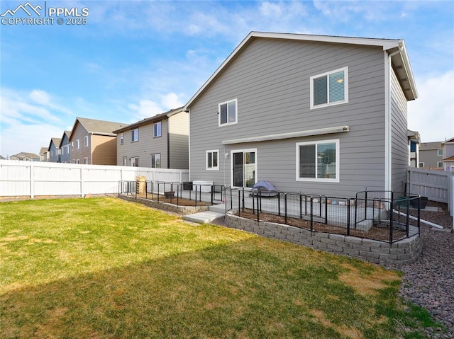 rear view of house with a vegetable garden, a fenced backyard, a yard, and a patio area