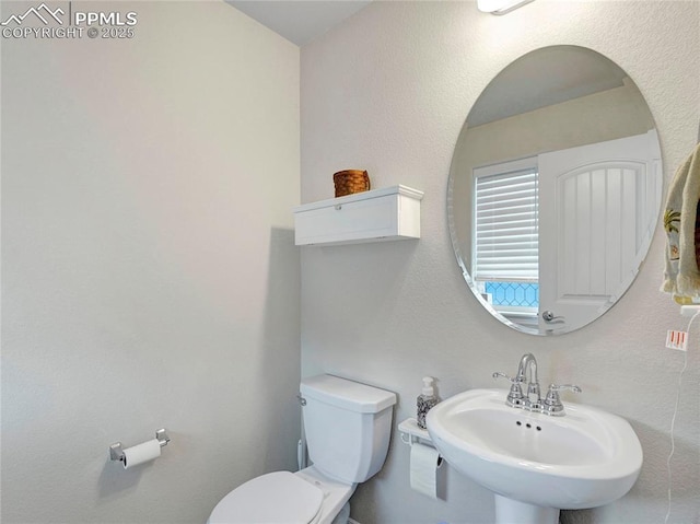 bathroom with toilet and a sink
