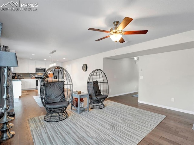 living area with baseboards, light wood-style floors, recessed lighting, and a ceiling fan
