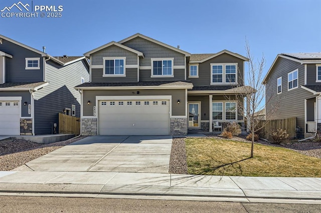 craftsman-style house featuring a porch, stone siding, fence, an attached garage, and driveway