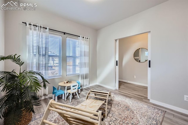 living area featuring wood finished floors and baseboards