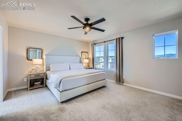 carpeted bedroom with baseboards and a ceiling fan
