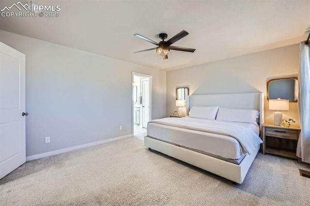 bedroom with ceiling fan, baseboards, carpet, and ensuite bath