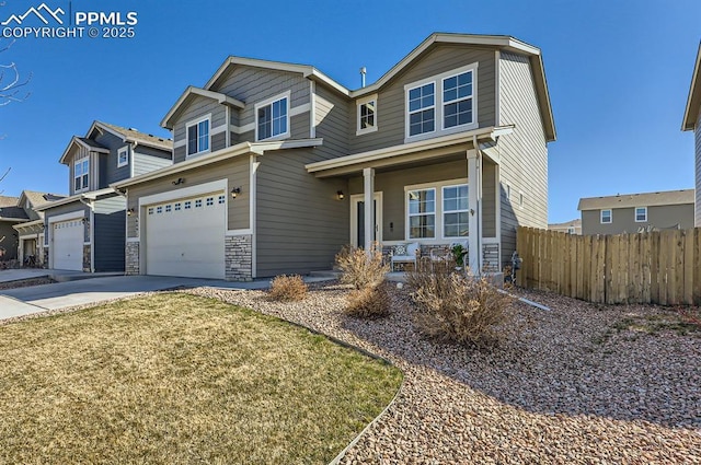 craftsman inspired home featuring driveway, a garage, stone siding, and fence