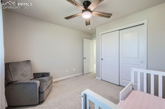 bedroom with light carpet, a closet, baseboards, and a ceiling fan