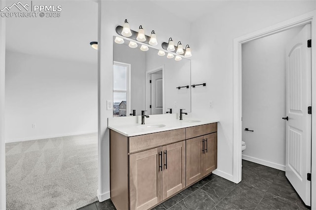 8532 Noreen Falls Dr, Colorado Springs, CO 80924 - bathroom featuring double vanity, toilet, and baseboards