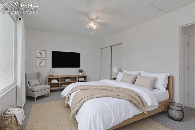 bedroom featuring carpet, a closet, and a ceiling fan