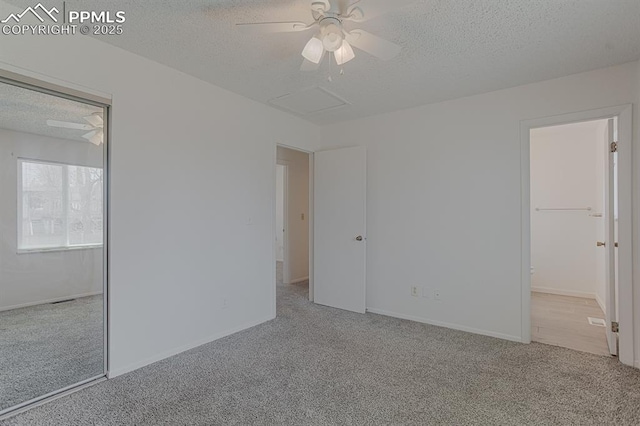 unfurnished bedroom with ceiling fan, a textured ceiling, baseboards, and carpet floors