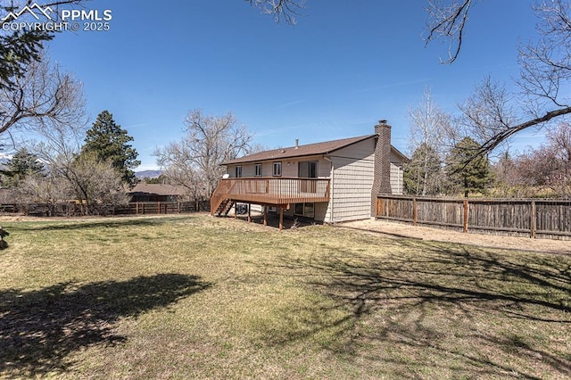 back of property with a yard, a fenced backyard, stairs, a chimney, and a deck