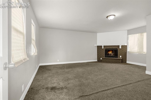 738 Harrison Pl, Colorado Springs, CO 80905 - unfurnished living room featuring carpet, healthy amount of natural light, baseboards, and a brick fireplace
