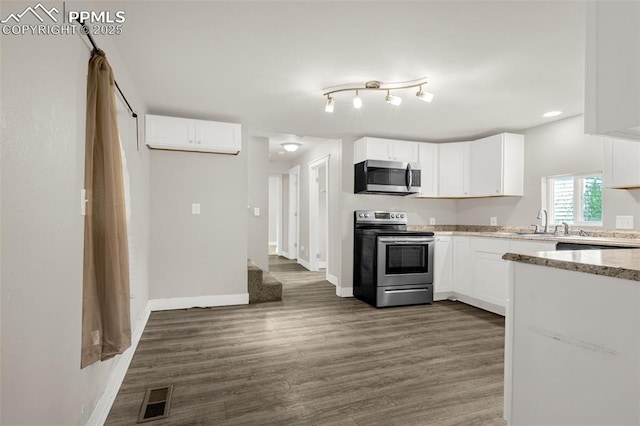 738 Harrison Pl, Colorado Springs, CO 80905 - kitchen with stainless steel appliances, white cabinets, and dark wood-style floors