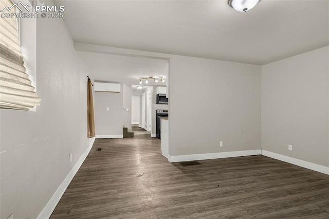 738 Harrison Pl, Colorado Springs, CO 80905 - unfurnished room with baseboards and dark wood-style flooring