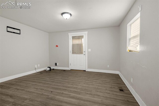 738 Harrison Pl, Colorado Springs, CO 80905 - unfurnished room featuring dark wood-type flooring and baseboards