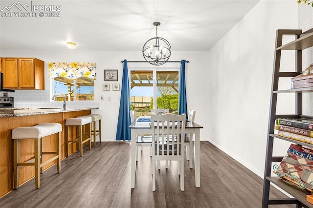 2951 Poughkeepsie Dr, Colorado Springs, CO 80916 - dining space with a chandelier, baseboards, and dark wood finished floors