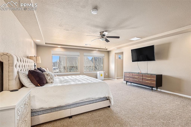 bedroom with baseboards, a ceiling fan, a textured ceiling, and light carpet