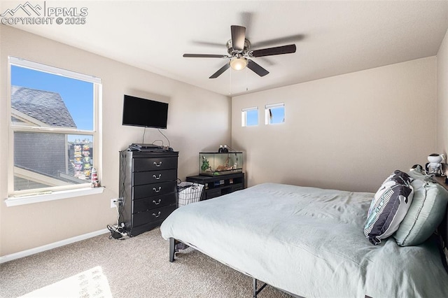 carpeted bedroom featuring baseboards and ceiling fan