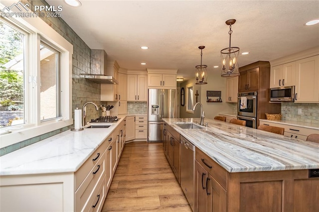 18383 Lazy Summer Way, Monument, CO 80132 - kitchen featuring appliances with stainless steel finishes, a sink, recessed lighting, a large island with sink, and decorative backsplash