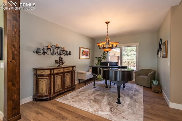 18383 Lazy Summer Way, Monument, CO 80132 - living area featuring wood finished floors, a chandelier, and baseboards