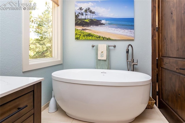 18383 Lazy Summer Way, Monument, CO 80132 - bathroom with a freestanding bath, vanity, a water view, and a textured wall