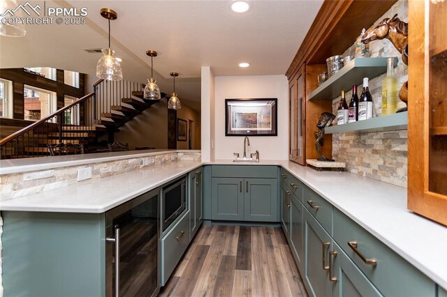 18383 Lazy Summer Way, Monument, CO 80132 - indoor wet bar featuring beverage cooler, stairway, dark wood-style flooring, recessed lighting, and pendant lighting