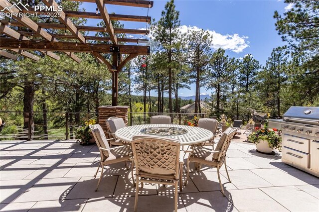 18383 Lazy Summer Way, Monument, CO 80132 - view of patio / terrace with a pergola, grilling area, outdoor dining area, and a mountain view
