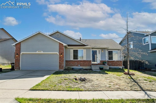 6627 Wagon Ridge Dr, Colorado Springs, CO 80923 - single story home with an attached garage, concrete driveway, fence, and brick siding