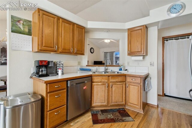 6627 Wagon Ridge Dr, Colorado Springs, CO 80923 - kitchen with light wood-style floors, ceiling fan, dishwasher, a sink, and brown cabinets