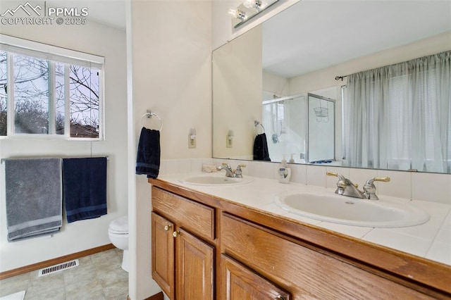 6627 Wagon Ridge Dr, Colorado Springs, CO 80923 - full bathroom featuring a shower stall, double vanity, visible vents, and a sink