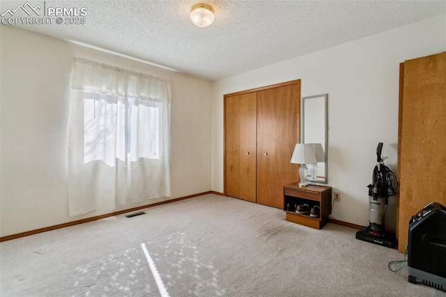 6627 Wagon Ridge Dr, Colorado Springs, CO 80923 - unfurnished bedroom featuring visible vents, a closet, carpet floors, and a textured ceiling