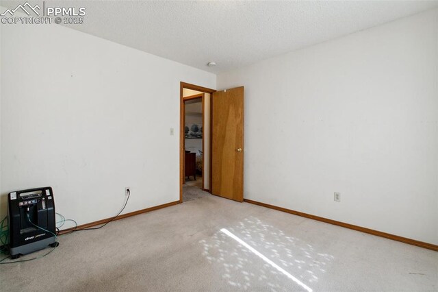 6627 Wagon Ridge Dr, Colorado Springs, CO 80923 - unfurnished room with carpet flooring, a textured ceiling, and baseboards