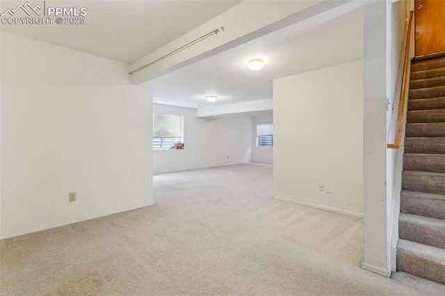 6627 Wagon Ridge Dr, Colorado Springs, CO 80923 - below grade area with baseboards, stairway, and light colored carpet