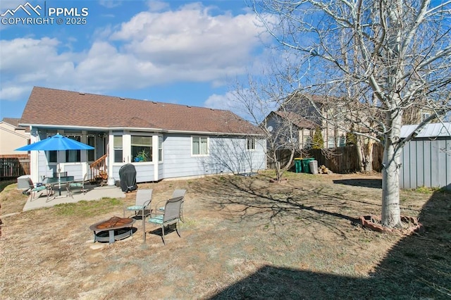 6627 Wagon Ridge Dr, Colorado Springs, CO 80923 - rear view of property featuring a patio, an outdoor structure, a fenced backyard, an outdoor fire pit, and a storage unit