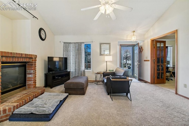 6627 Wagon Ridge Dr, Colorado Springs, CO 80923 - carpeted living room with baseboards, ceiling fan, a brick fireplace, and lofted ceiling