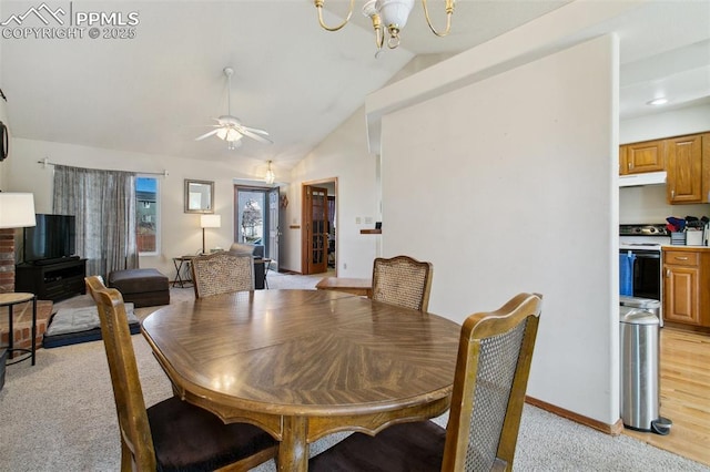 6627 Wagon Ridge Dr, Colorado Springs, CO 80923 - dining area with light carpet, ceiling fan with notable chandelier, baseboards, and lofted ceiling