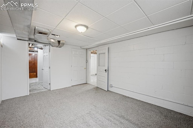 finished below grade area with carpet floors and a paneled ceiling
