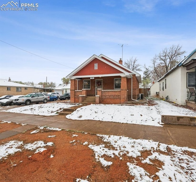 view of front of house with a porch and brick siding