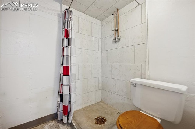 full bath featuring toilet and a shower stall