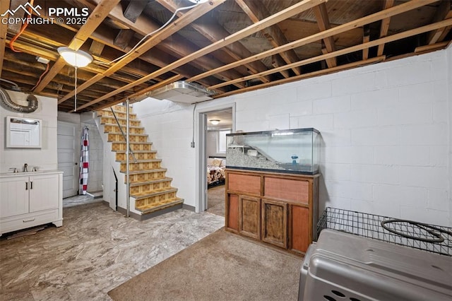 finished below grade area with a sink and stairway