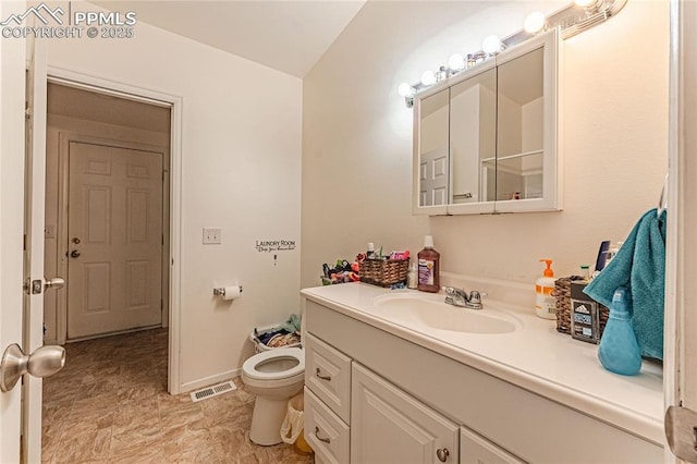 735 E Vermijo Ave, Colorado Springs, CO 80903 - bathroom with toilet, vanity, visible vents, and baseboards
