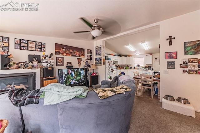 735 E Vermijo Ave, Colorado Springs, CO 80903 - living area featuring ceiling fan, vaulted ceiling, dark colored carpet, and a fireplace