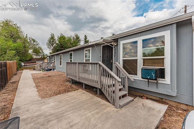 735 E Vermijo Ave, Colorado Springs, CO 80903 - exterior space featuring fence, a patio area, a wooden deck, and cooling unit