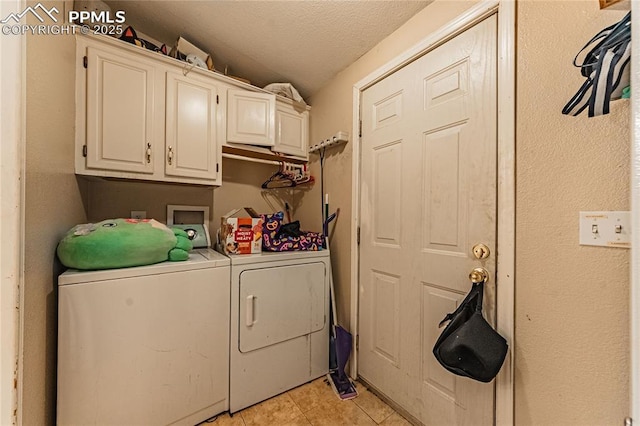 735 E Vermijo Ave, Colorado Springs, CO 80903 - laundry room featuring washing machine and clothes dryer, cabinet space, a textured ceiling, and light tile patterned flooring