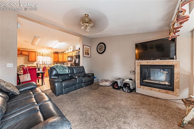 735 E Vermijo Ave, Colorado Springs, CO 80903 - living area featuring a fireplace, carpet flooring, and a ceiling fan